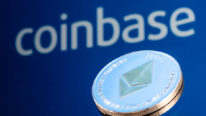 Coinbase (COIN), is an American company that operates a cryptocurrency exchange platform. Ethereum coin (ETH-USD) on the background of the Coinbase logo.