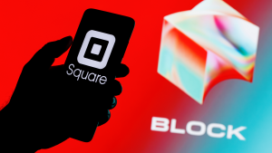 Square, Inc. changes name to Block (SQ). Smartphone with Square logo on screen in hand against Block logo background.