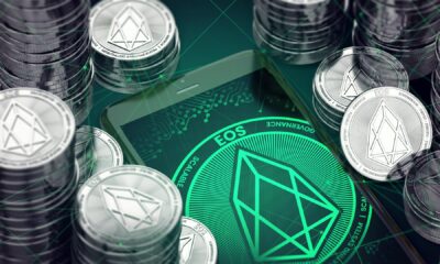 EOS-stacked-coins-with-green-background-of-EOS-logo.