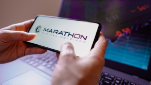 In this photo illustration, the Marathon Digital Holdings (MARA) logo displayed on a smartphone screen