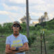 Cheryl Shadden stands outside her home in Granbury, Texas, with a view of Constellation Energy's Wolf Hollow II power plant in the background. Credit: Keaton Peters/Inside Climate News